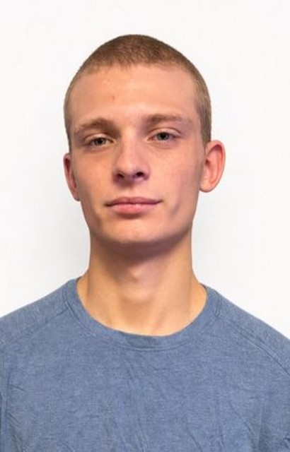 Casper Levesque actor headshot, wearing a blue shirt against a white background